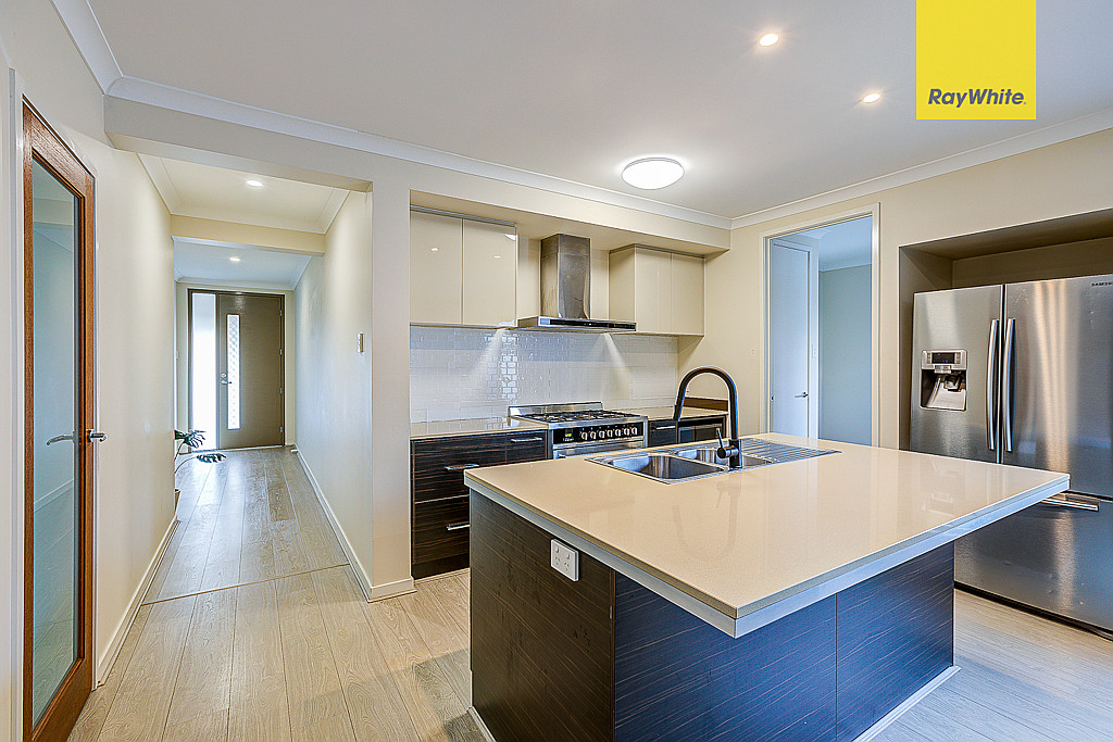 Kitchen with island bench and stainless appliances
