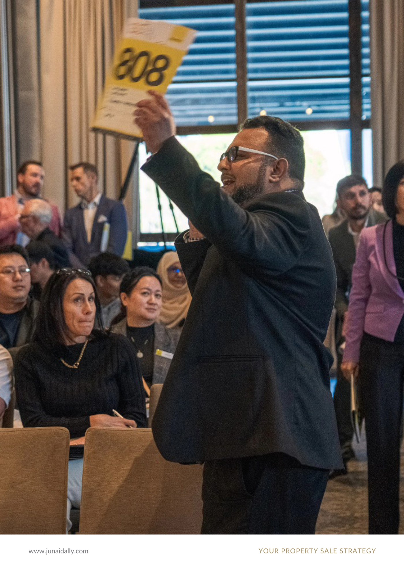 Junaid Ally bidding on behalf of a client at a Ray White auction